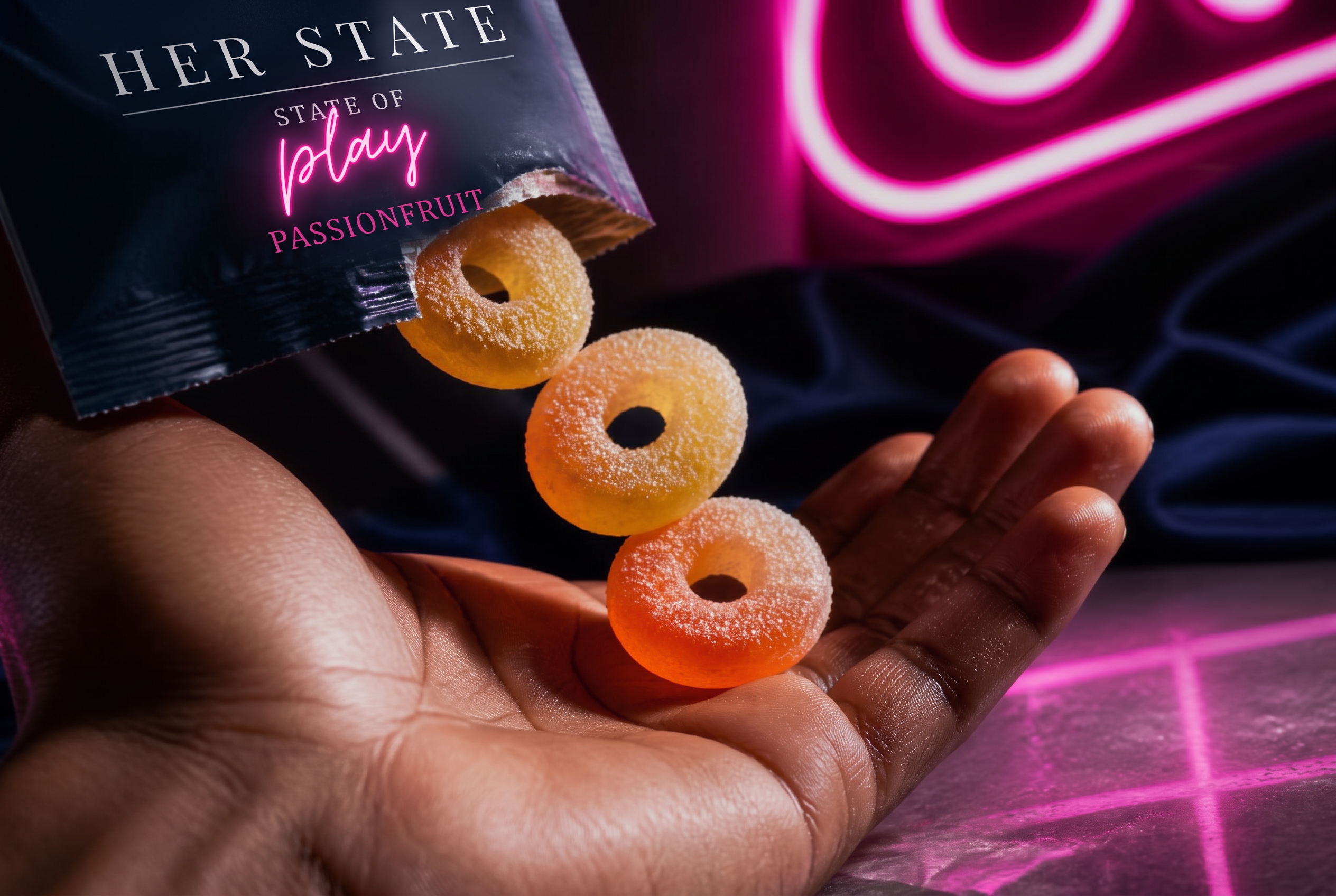 Sugar-coated passionfruit gummy rings tumbling from the torn Her State packet into an open palm under pink neon